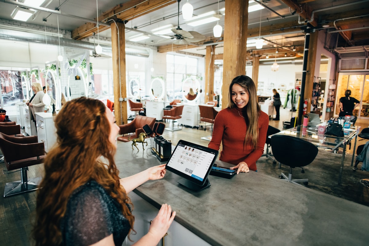 Business owner taking a card payment at the counter on a payment terminal.